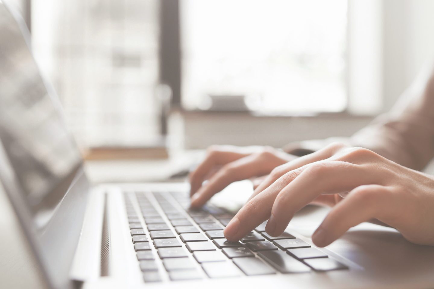 Construction cybersecurity Fingers on laptop keyboard