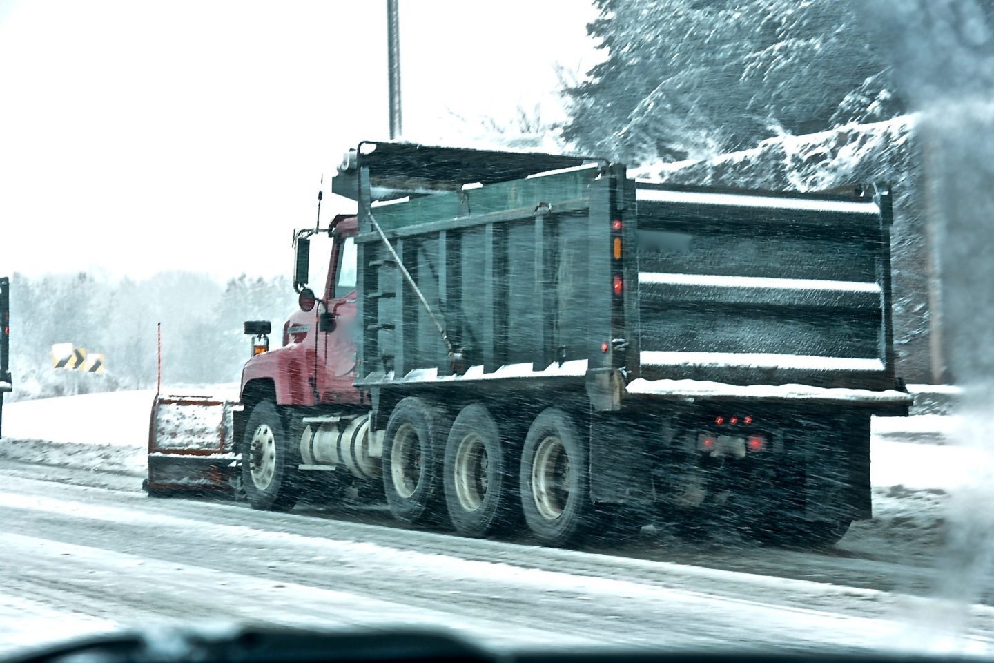 snow plow cleaning a road