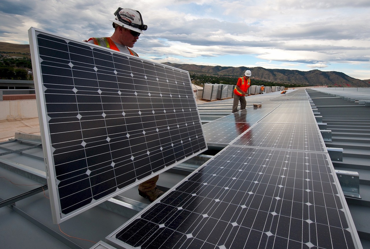 commercial construction workers installing solar panels