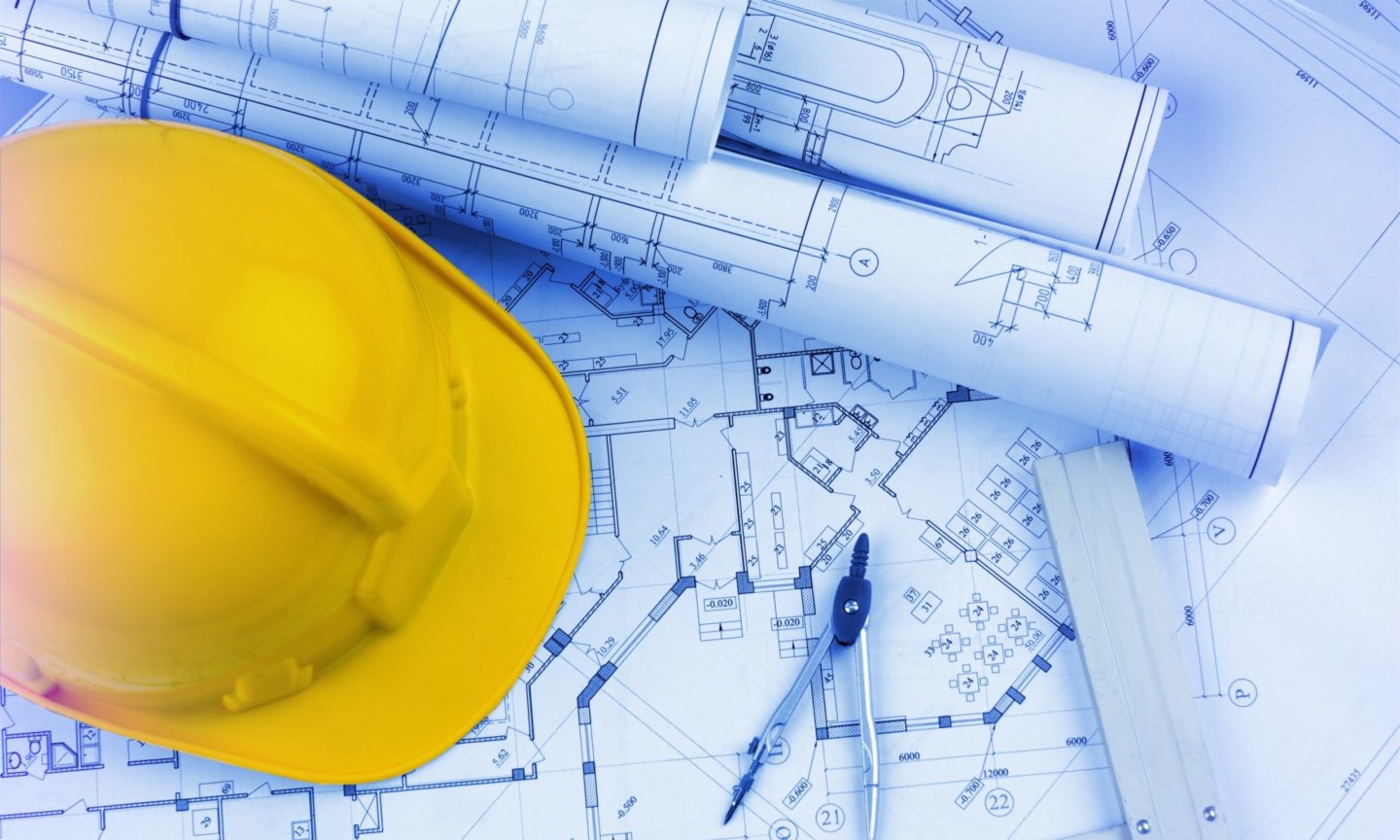 Construction Finance Blueprint with yellow hard hat