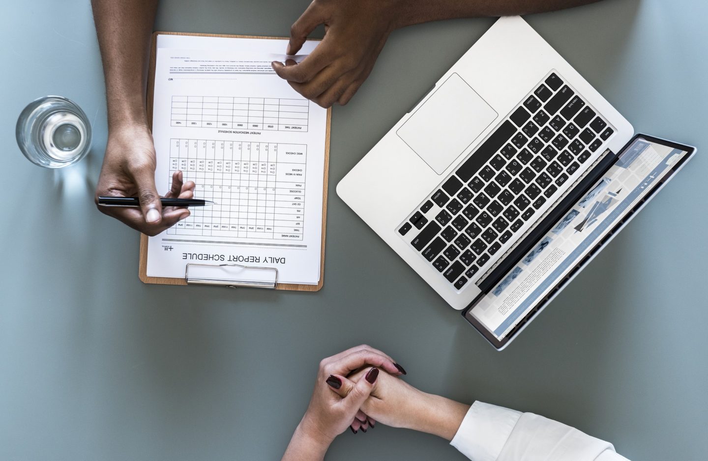 meeting over a clipboard and laptop