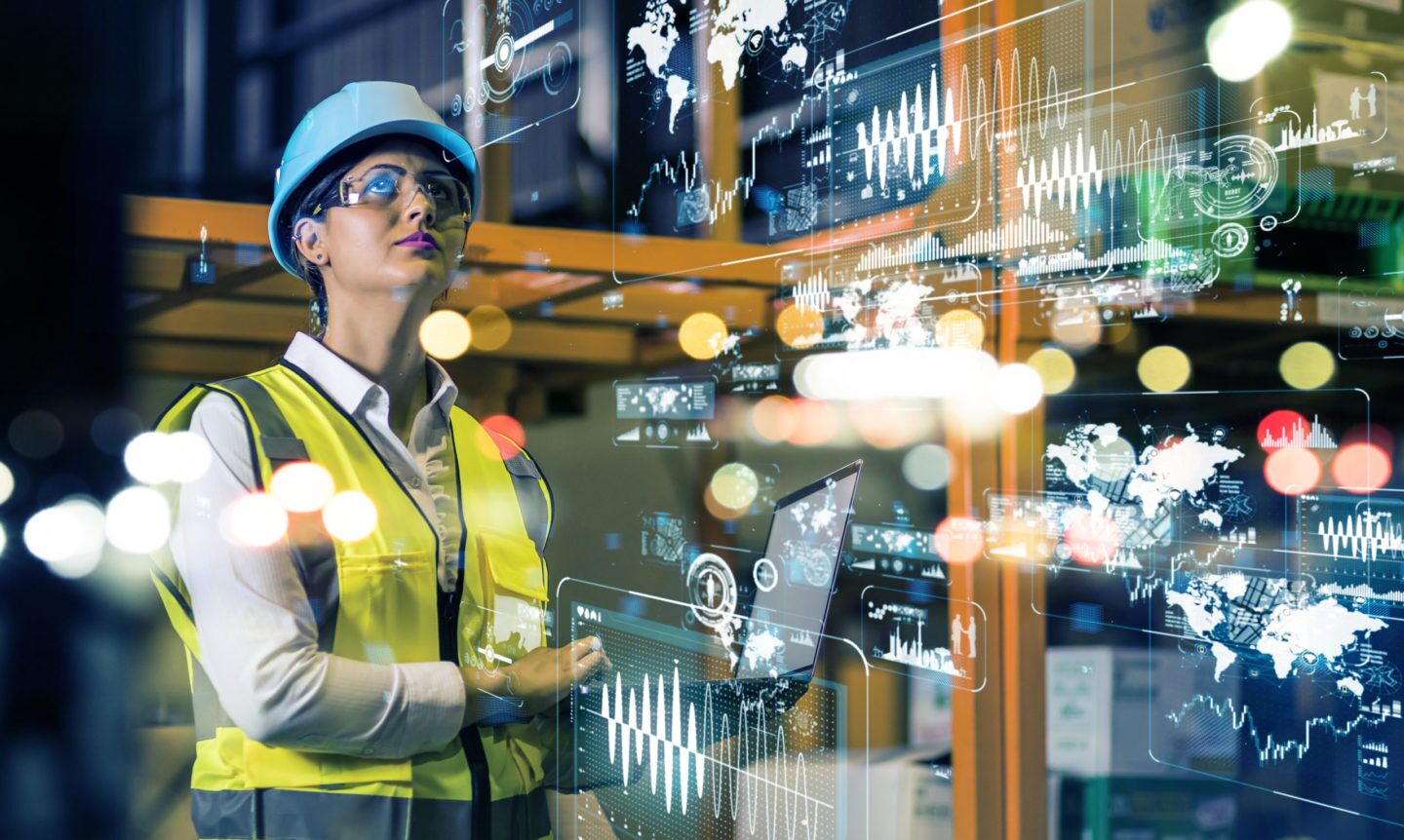 Manufacturing employee with screens overlaid in glass